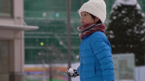 Cute Asian Child Playing Snow In The Park