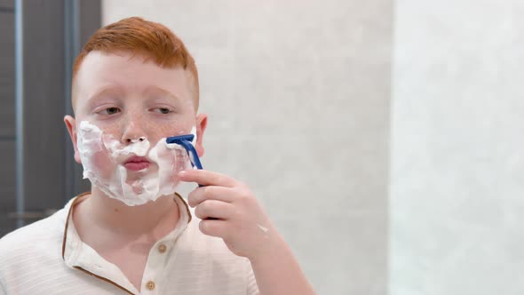 Little Boy is Shaving His Face in the Bathroom