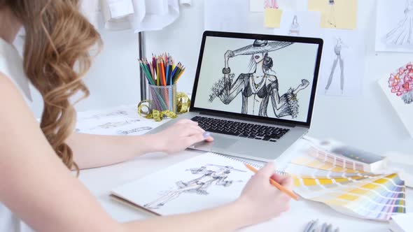 Designer Draws Sketches and Scrolls Electronic Drawings on the Computer