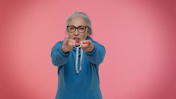 Senior Old Granny Woman Pointing Around with Finger Gun Gesture Shooting Killing with Hand Pistol