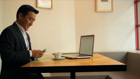 Businessman using mobile phone at table 