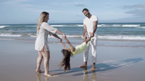 Happy Mom and Dad Playing Active Games with Little Daughter