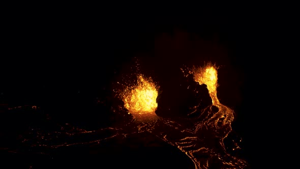 Aerial view of a lava flowing volcano fire fountains - reverse, drone shot