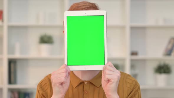 Rear View of Young Man Using Tablet with Chroma Screen