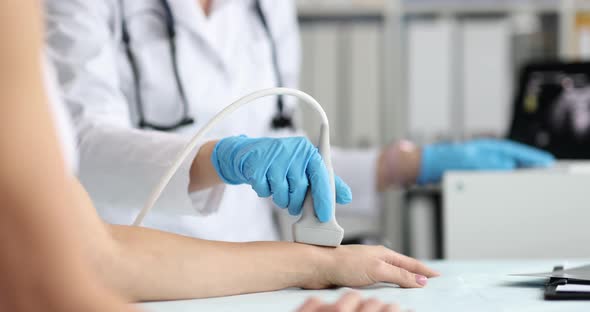 Ultrasound Technician Examines Wrist and Hand Bones of Young Woman