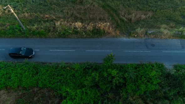 Country side road with cars and fields