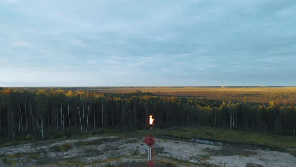 A Drone Lands Above a Burning Torch at an Oil Field in the Swamps of Siberia