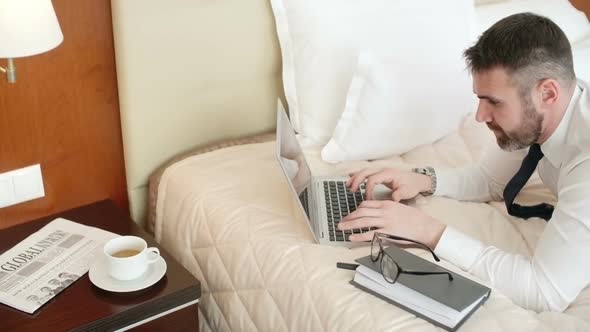 Businessman Working in Hotel Room