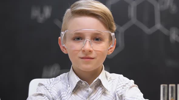 Smiling Schoolboy Sitting on Chemistry Lesson, Educational Laboratory, Close-Up