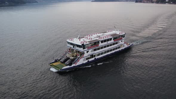 Ferry transporting cars to Bellagio on scenic Lake Como; aerial shot