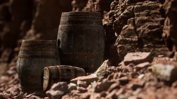 Old Wooden Vintage Wine Barrels Near Stone Wall in Canyon