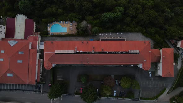 Aerial top-down rising over roof of Golden Tulip Caramulo hotel and spa, Portugal