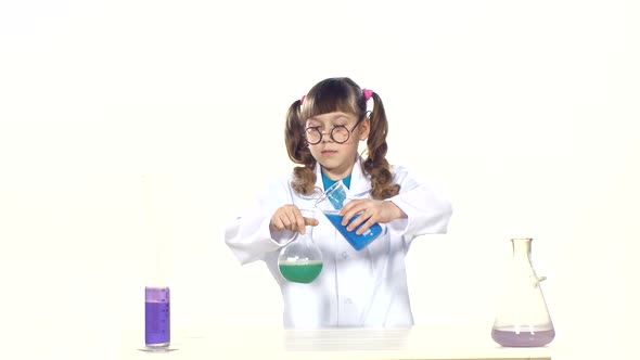 Serious, Little Girl with Ponytails in Uniform and Round Glasses Making Chemical Experiments -