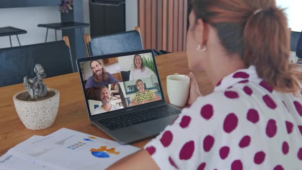 Young Red Haired Business Woman Wearing Headphones Communicating By Video Call