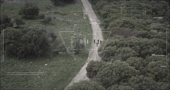 Surveillance drone camera view of terrorist squad walking with weapons