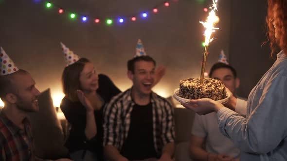 Friends Celebrating Birthday Party Surprising Friend with Cake with Burning Sparkling Stick