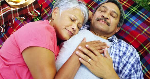 Senior couple laying on blanket