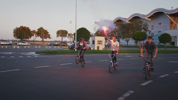 Young Men are Riding Bmx Bikes By the Road Leading From the Mall and Doing Tricks One of Them is