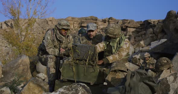 Armed African American Soldier Looking at a Computer alt