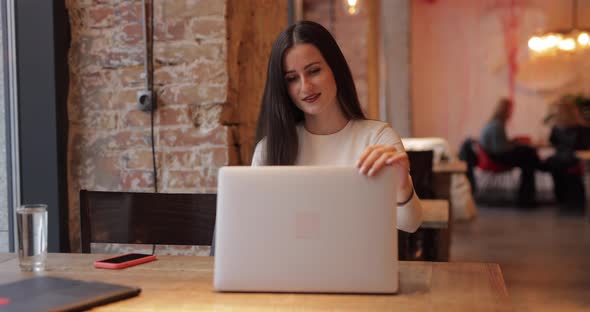 Freelancer Woman Works By Laptop PC in Cafe