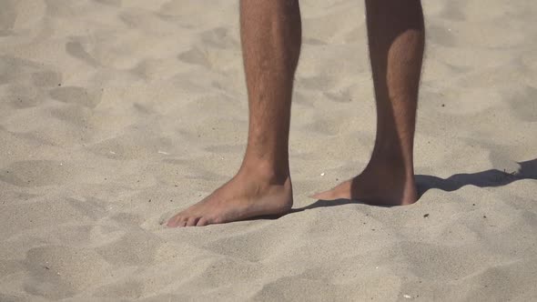 Detail of a mans feet while playing pro beach volleyball.