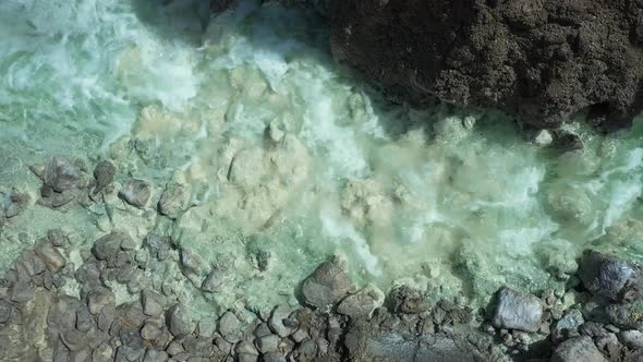 Dead Sea Hot Springs dramatic aerial top down shot of crystal clear warm waters flowing through dese