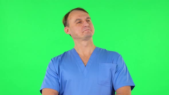 Medical Man Stands in Expectation Then Proudly Smiles. Green Screen