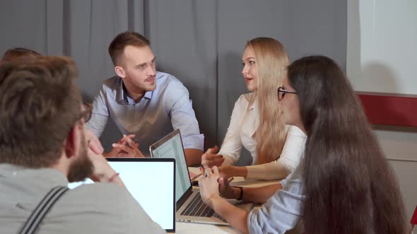 Male and Female Colleagues Are Chatting at Briefing in Office