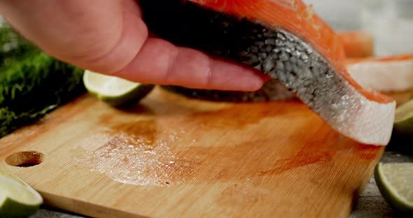 A Raw Piece of Salmon Is Placed on the Cutting Board