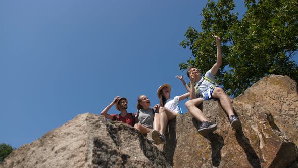 Smiling Hikers Taking Selfie at Mountain Peak