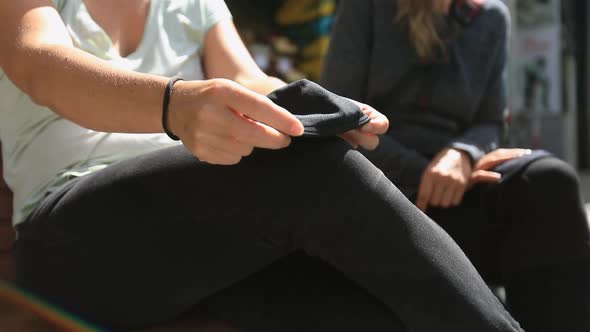 Woman Removing Mask and Keeping on Leg Knee