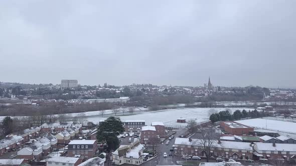 Tracking drone shot of snowy Exeter subburbs looking towards the town centre
