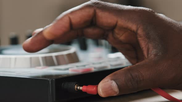 Closeup Male Hands of Unrecognizable African American Man DJ Musician Sound Engineer in Studio Club