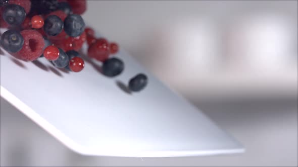 Berries Rolling Down a Cutting Board in Slow Motion