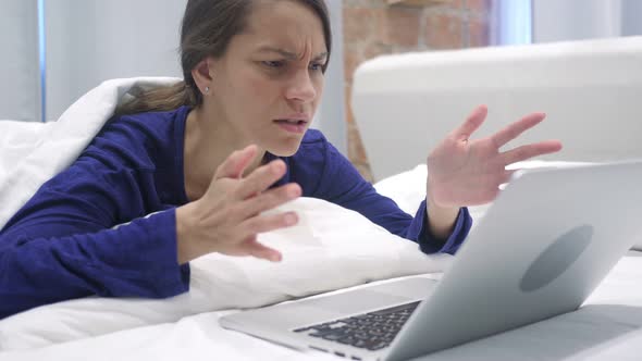 Upset Hispanic Woman in Bed Losing Work Online, Disaster