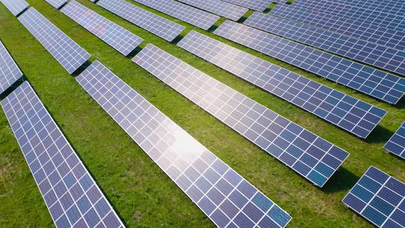 Flight Over a Field of Solar Panels in Sunny Summer Day