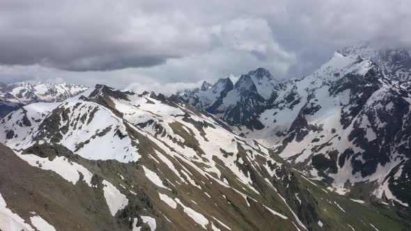 Flight above snowcapped mountains near Elbrus