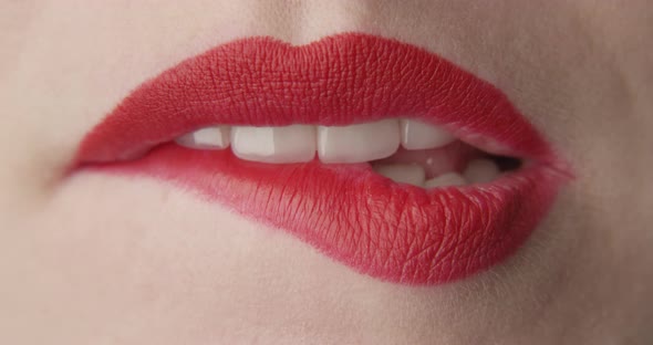 Teeth Bitting Red Lips A Macro Shot Of Female Mouth