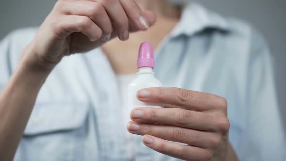 Woman's Hand Holding Nasal Spray and Pressing on It, Healthcare and Medicine