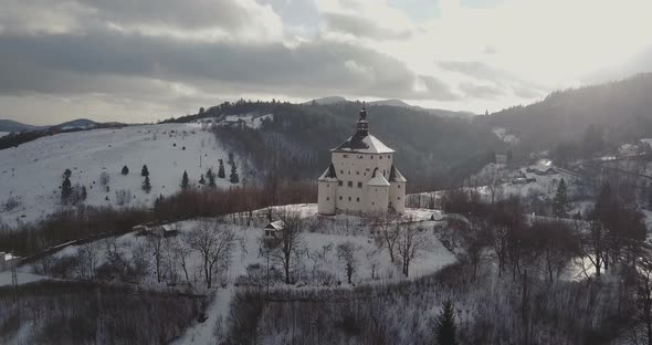 Flying towards a New Castle in Mining town Banska Stiavnica in winter, Sunny, Aerial shot