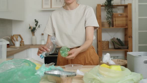 Close Up of Woman Sorting Plastics at Home