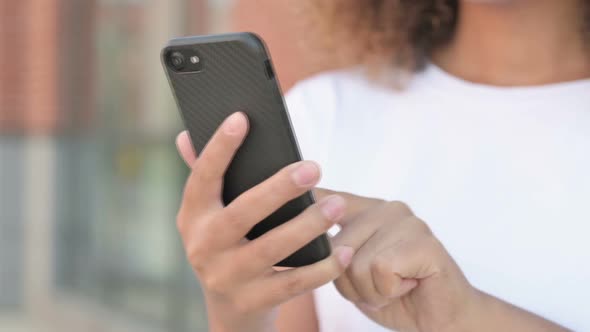 Close Up of African Woman Browsing Internet on Smartphone