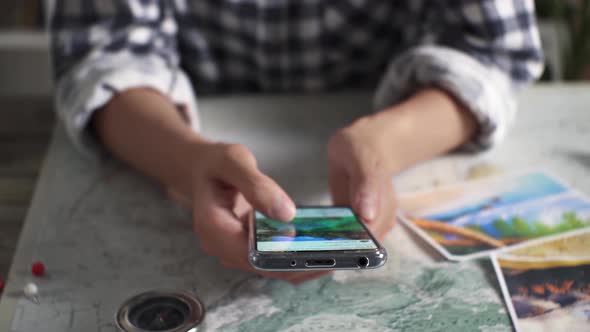 A Young Girl Tourist Explores Travel Destinations On Her Smartphone While Looking At Motivating