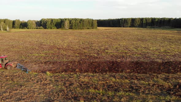 Tractor Plowing brown Field