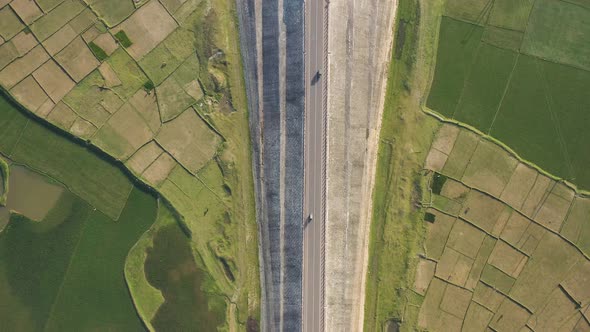 Aerial view of a road among the fields in Sapahar, Rajshahi, Bangladesh.