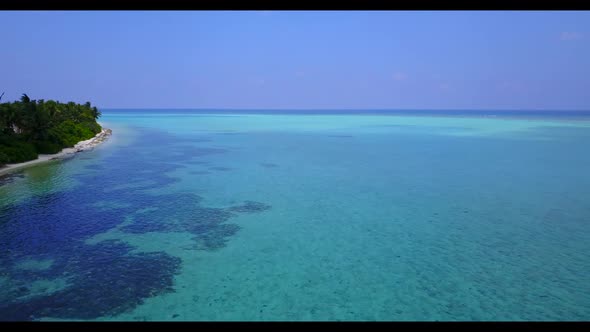 Aerial top view seascape of exotic seashore beach time by transparent lagoon with bright sand backgr