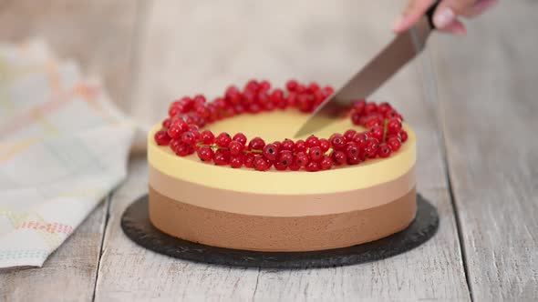 Cutting a Triple Chocolate Mousse Cake with Red Currant