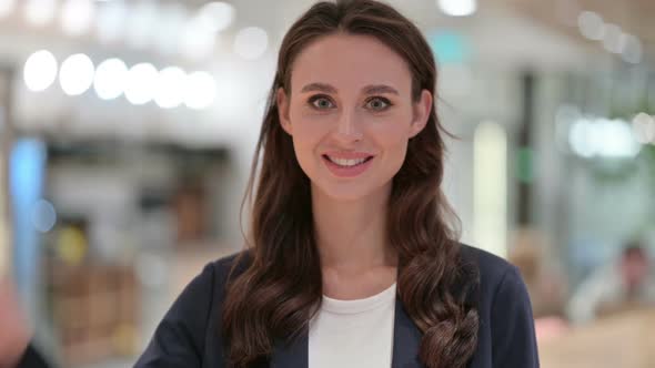 Portrait of Positive Businesswoman with Victory Sign By Hand