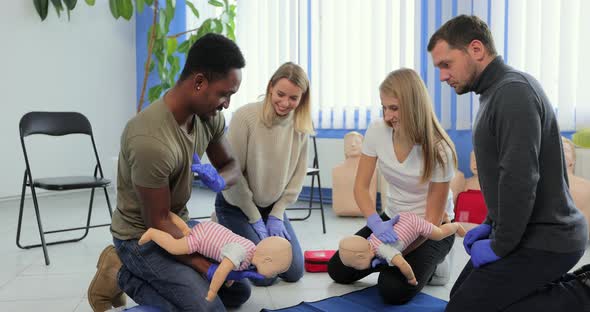 Group of Multiethnic People During the First Aid Training with Instructor Showing on Manikin How to