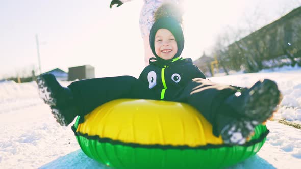 Happy Children Play with Winter Skating Ring at Winter Holidays